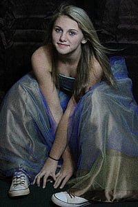 woman wearing blue and brown strapless gown sitting on black surface thumbnail