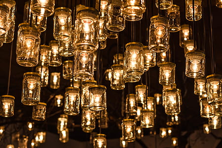 photography of hanging clear glass jars with bulbs at nightime thumbnail