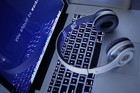white Beats by Dr. Dre headphones on top MacBook thumbnail