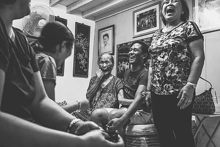 grayscale photo of a group of people laughing thumbnail