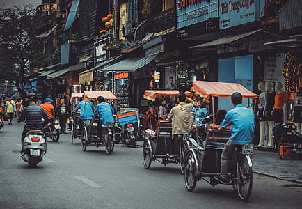 people riding carts on road at daytime thumbnail