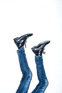 person wearing blue jeans and black leather boots thumbnail