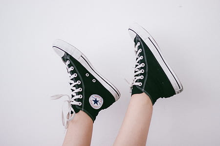 person wearing black-and-white Converse All-Star high-top sneakers thumbnail