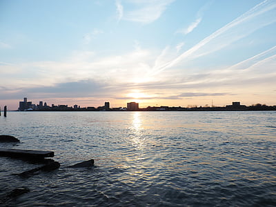 calm sea near buildings under blue sky thumbnail
