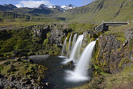 waterfalls on side of cliff with bridge at daytime thumbnail
