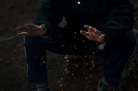 person in black pants sits on stone thumbnail
