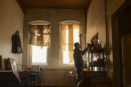 man inside the room standing near the door thumbnail