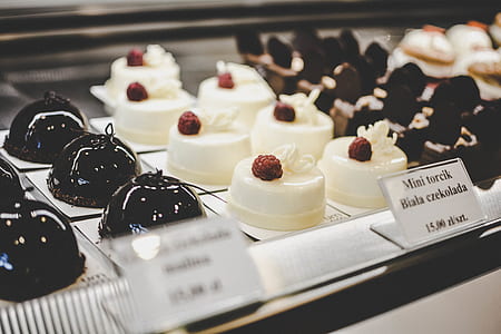 white icing-covered cakes in display shelf thumbnail