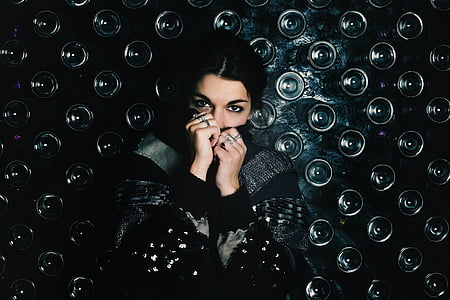 person wearing black and gray long-sleeved top and silver-colored rings thumbnail