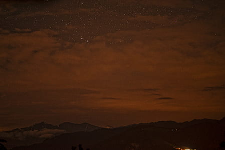 silhouette of mountain during night time thumbnail