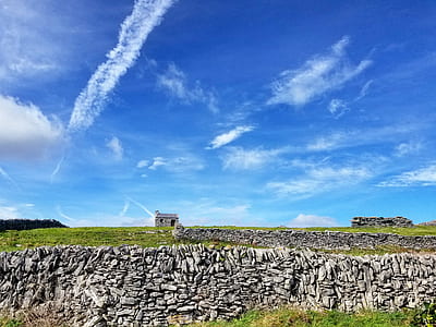 grey stone house under blue sky thumbnail