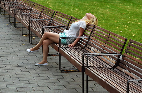 woman in white shirt sitting on park bench thumbnail
