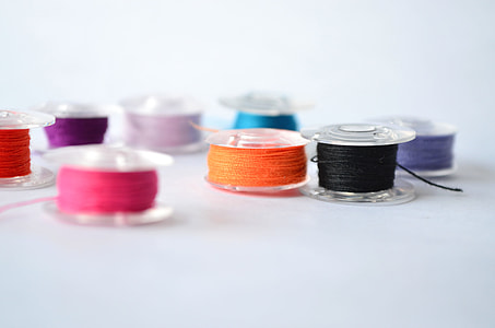 shallow focus photography of assorted-color threads thumbnail