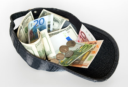 assorted banknotes and coins in black cap thumbnail