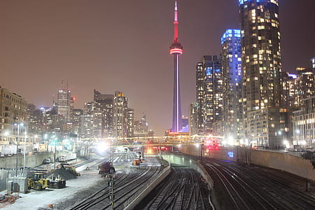 Train Tracks at night near CN Tower and skyscrapers in Toronto, Canada thumbnail