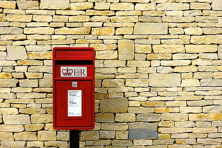red steel container beside brick wall thumbnail