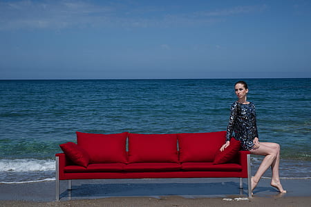 woman sitting on red sofa thumbnail