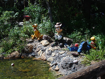 Mickey Mouse fishing statuette near green leaf plant thumbnail