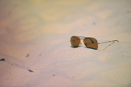 photo of brown tinted sunglasses on gray sand thumbnail