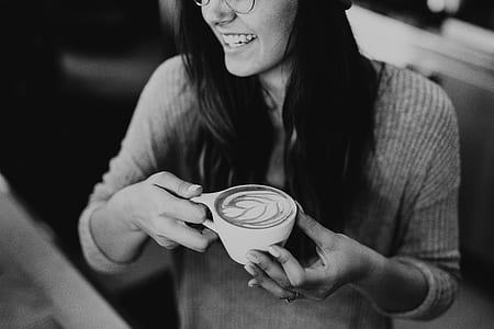 grayscale photography of woman holding mug thumbnail