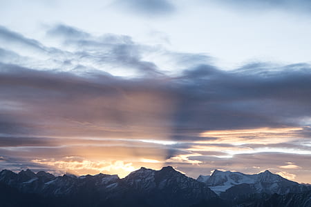skyline on gray mountain under cloudy sky thumbnail