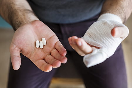 Man Holding Three White Medication Pills thumbnail