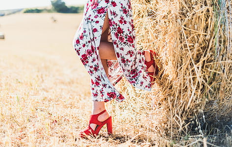 woman wearing slit dress leaning against bale of hay thumbnail