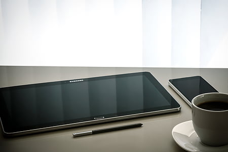 black Samsung Galaxy Tab on gray surface thumbnail