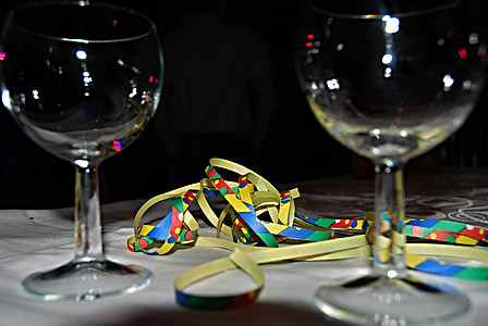 two clear wine glasses near yellow and multicolored tie thumbnail