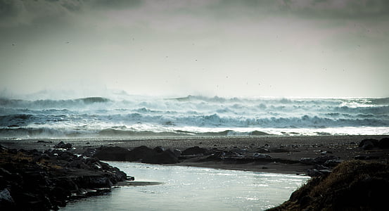body of water between rocks during daytime thumbnail