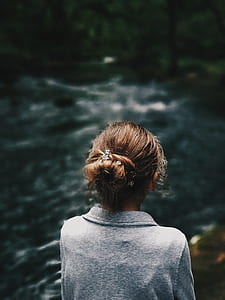woman watching river during daytimne thumbnail