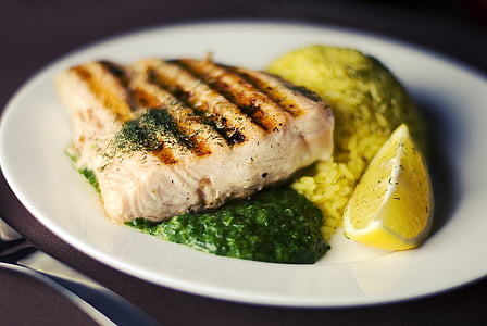 grilled fish with rice and sliced lemon thumbnail