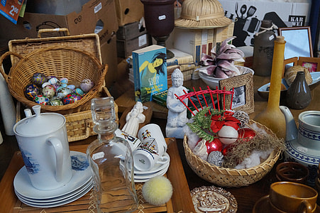 assorted figurines, plates, mugs and jars on table thumbnail