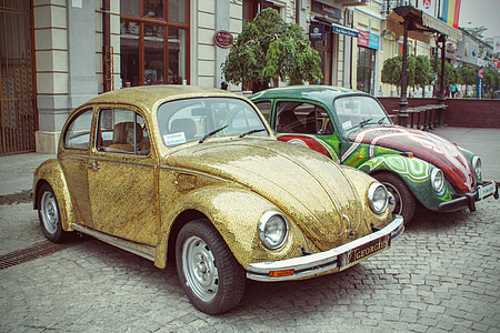 two assorted-color Volkswagen Beetle coupe thumbnail