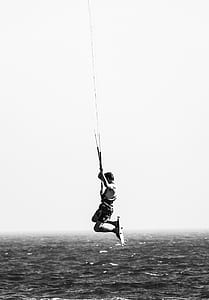 grayscale photo of person riding wake board thumbnail