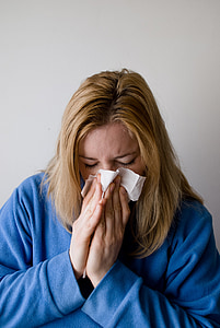 woman covering her nose and mouth with white paper thumbnail