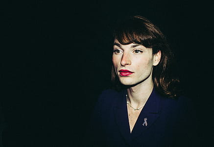 Woman Wearing Blue Coat in a Dark Area thumbnail