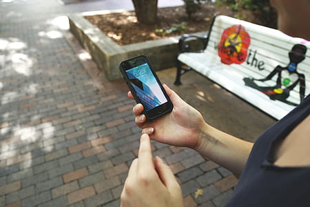 person holding black iPhone 5 thumbnail
