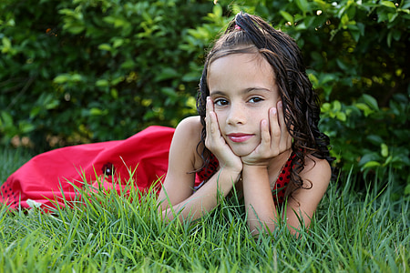 girl in red dress on green grass thumbnail