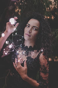Photography of a Woman Holding String Lights thumbnail