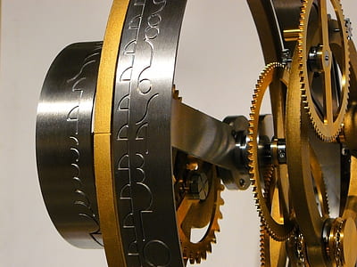 grey and brass-colored mechanical gears close-up photo thumbnail
