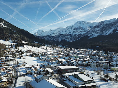 bird's-eye view photography of town beside mountain foot thumbnail