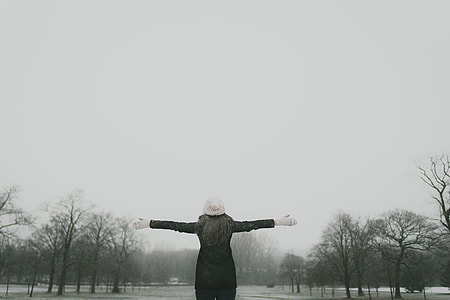 woman wearing black long sleeved jacket with white headdress and hand gloves thumbnail