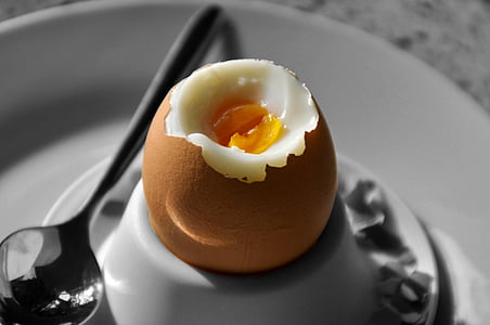 boiled egg on plate beside spoon thumbnail