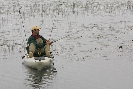 man sitting on kayak fishing thumbnail