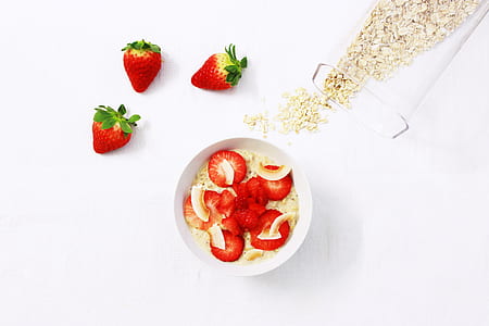 flat lay photography of three strawberries near white bowl filled by strawberry thumbnail