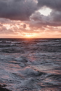 body of water during sunset thumbnail