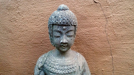 gray sculpture beside wall thumbnail