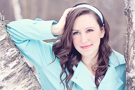 woman wearing teal long-sleeved top near tree during daytime thumbnail