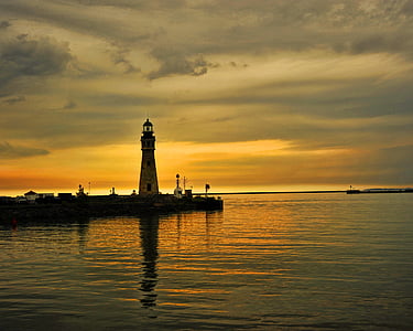lighthouse across body of water thumbnail